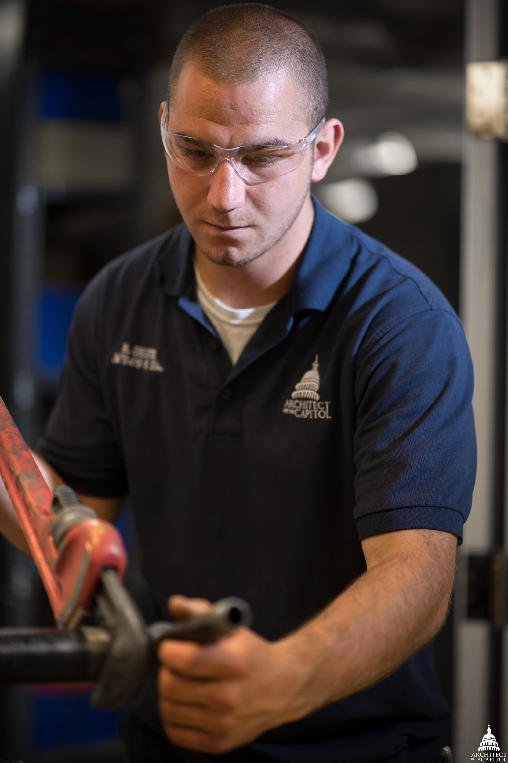 AOC's Randy Shontz, HVAC Equipment Worker, uses a wrench to fabricate a pipe.